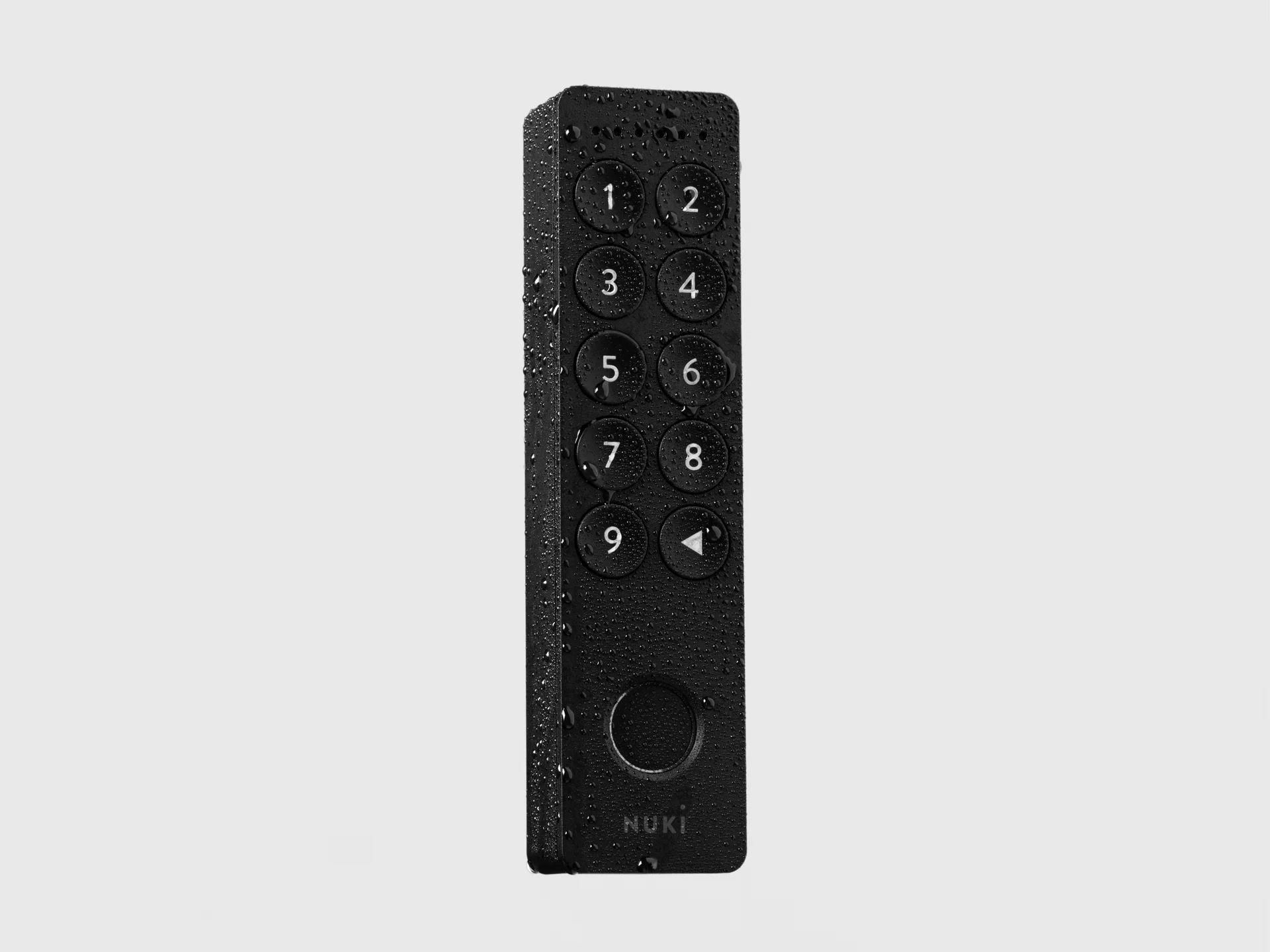 Nuki Keypad 2 covered in water droplets, highlighting its weatherproof design.